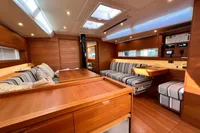 Luxurious interior of 2023 Solaris 50 yacht with wood finish and striped seating.