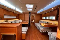 Luxurious interior of 2023 Solaris 50 yacht with wood finish and striped seating.