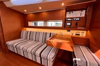 Luxurious interior of 2023 Solaris 50 yacht with striped seating and control panel.