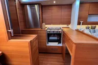 Interior of 2023 Solaris 50 yacht featuring modern wooden kitchen design.