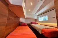 Interior of 2023 Solaris 50 yacht cabin with twin beds and modern lighting.