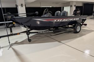 2026 Tracker Super Guide V-16 SC boat on trailer in showroom.