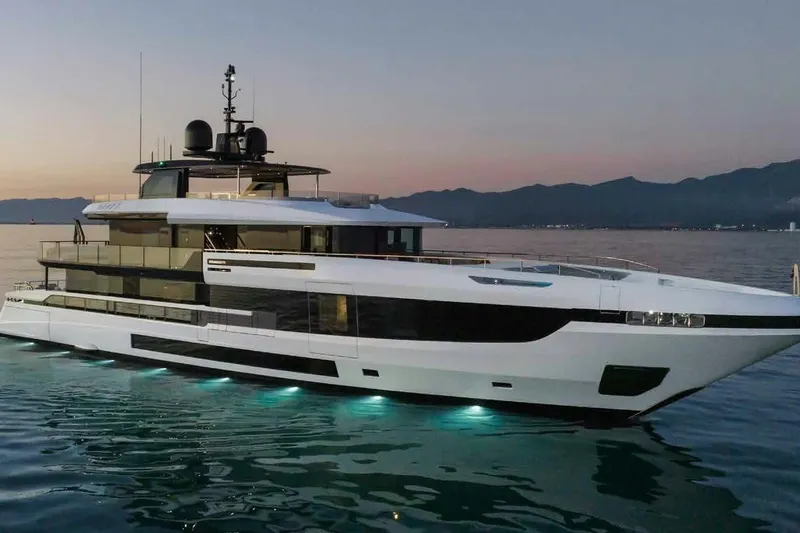 Oceano 44 Yacht Photos Pics Luxurious 2027 Mangusta Oceano 44 yacht at sunset, featuring sleek design and ambient lighting.