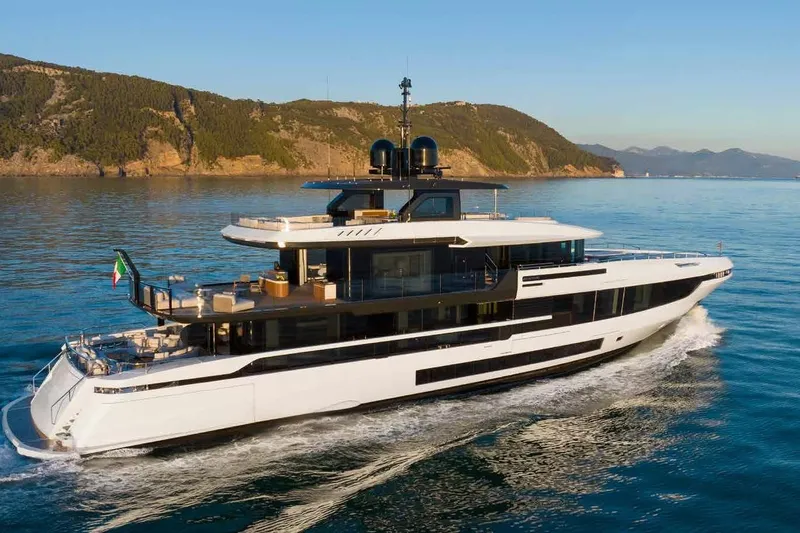 Oceano 44 Yacht Photos Pics Luxurious 2027 Mangusta Oceano 44 yacht cruising on serene waters near a scenic coastline.