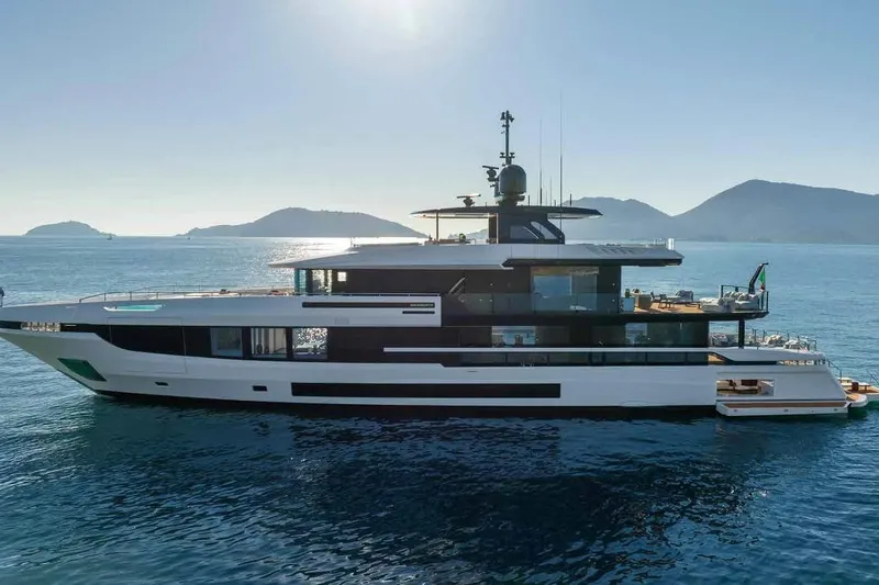 Oceano 44 Yacht Photos Pics Luxurious 2027 Mangusta Oceano 44 yacht cruising in serene waters with scenic mountain backdrop.