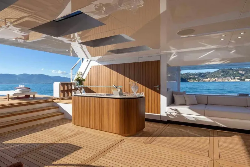 Oceano 44 Yacht Photos Pics Luxurious 2027 Mangusta Oceano 44 yacht interior with elegant wood finishes and scenic ocean view.