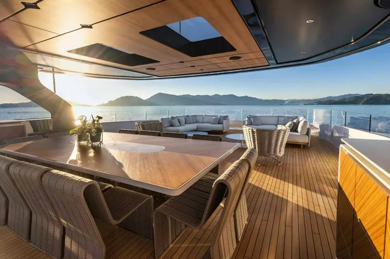 Oceano 44 Yacht Photos Pics Luxurious Mangusta Oceano 44 yacht deck with elegant seating, ocean view, and sunset ambiance, 2027 model.