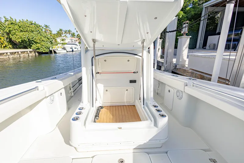 Done Deal Yacht Photos Pics 2015 Yellowfin 32 Offshore boat interior with open storage compartment, docked by the water.