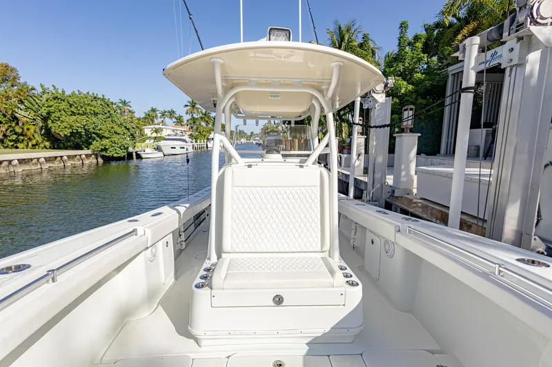 Done Deal Yacht Photos Pics 2015 Yellowfin 32 Offshore boat docked, featuring spacious seating and sleek design.