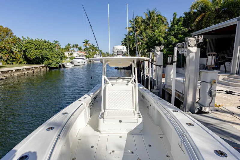 Done Deal Yacht Photos Pics 2015 Yellowfin 32 Offshore boat docked in a scenic canal setting.