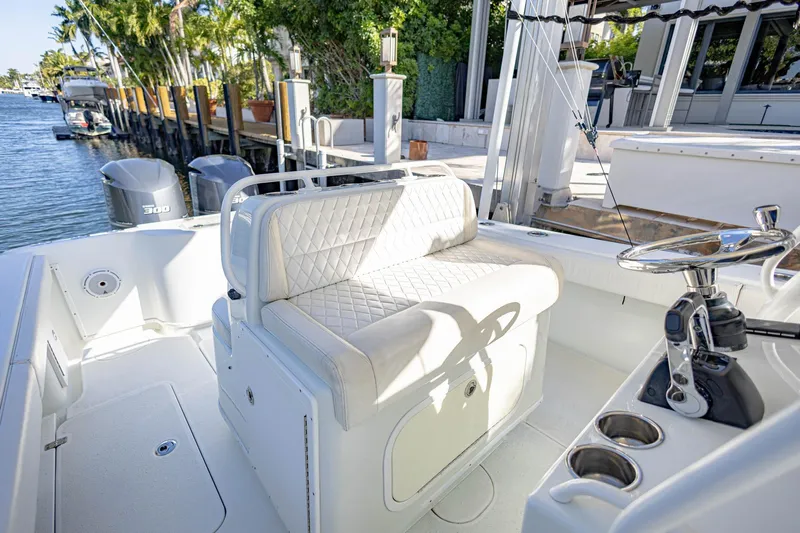 Done Deal Yacht Photos Pics 2015 Yellowfin 32 Offshore boat interior with seating and steering wheel.