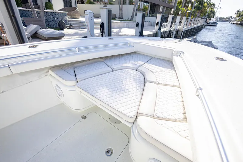 Done Deal Yacht Photos Pics 2015 Yellowfin 32 Offshore boat with cushioned seating in a marina setting.