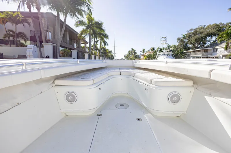 Done Deal Yacht Photos Pics 2015 Yellowfin 32 Offshore boat interior with white seating and palm trees in background.