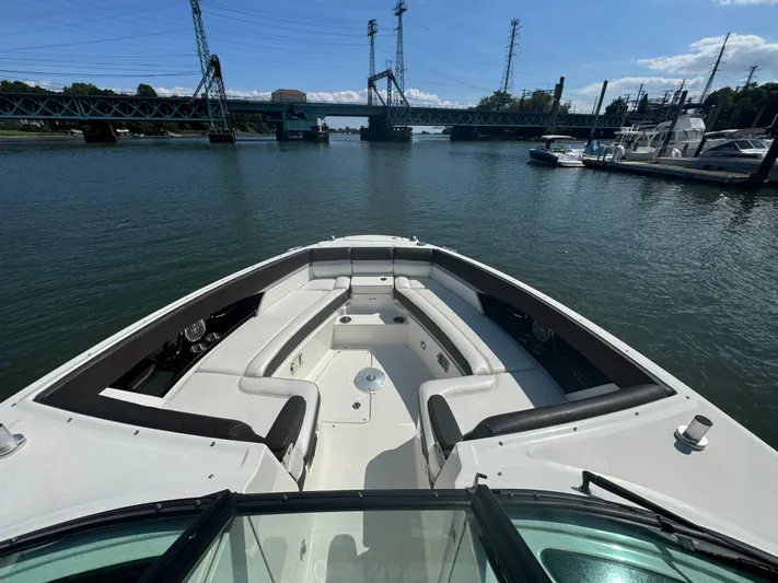  Yacht Photos Pics 2017 Sea Ray SLX 350 Outboard boat on calm water near a bridge and marina.
