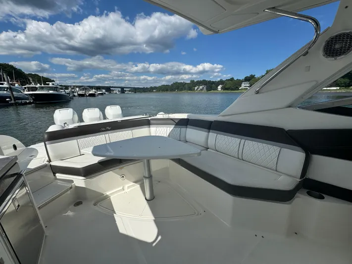  Yacht Photos Pics 2017 Sea Ray SLX 350 Outboard boat interior with seating and table, docked by the water.