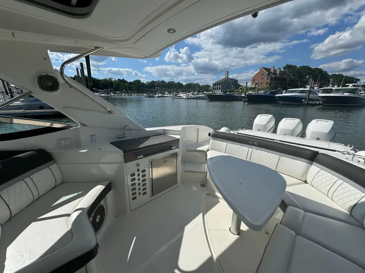  Yacht Photos Pics Interior of 2017 Sea Ray SLX 350 Outboard boat with seating and table, docked at marina.