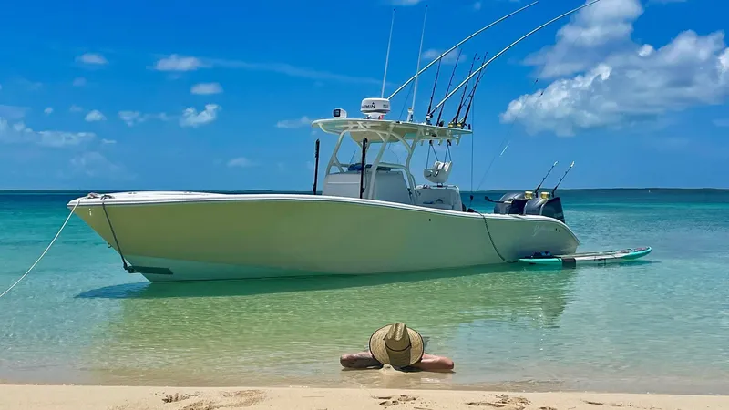 Done Deal Yacht Photos Pics 2015 Yellowfin 32 Offshore boat anchored on tropical beach.