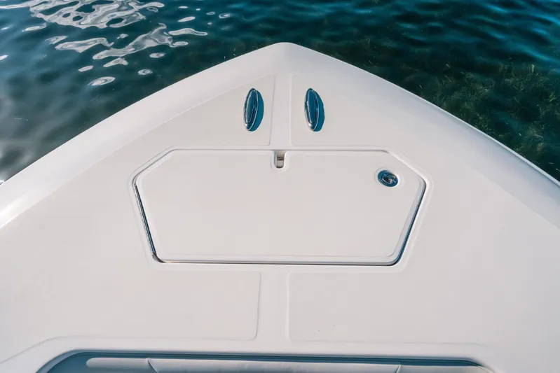  Yacht Photos Pics Bow of 2016 Invincible 42 Open Fisherman boat on clear water.