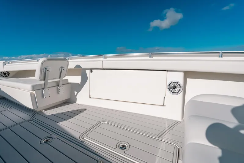  Yacht Photos Pics 2016 Invincible 42 Open Fisherman boat deck with seating, under clear blue sky.