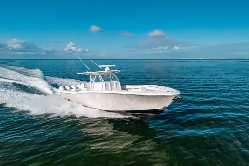  Yacht Photos Pics 2016 Invincible 42 Open Fisherman cruising on clear blue ocean waters.
