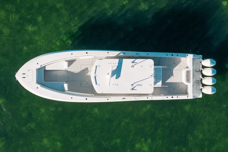  Yacht Photos Pics Overhead view of 2016 Invincible 42 Open Fisherman boat on clear green water.