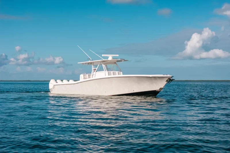  Yacht Photos Pics 2016 Invincible 42 Open Fisherman boat on calm ocean under blue sky.