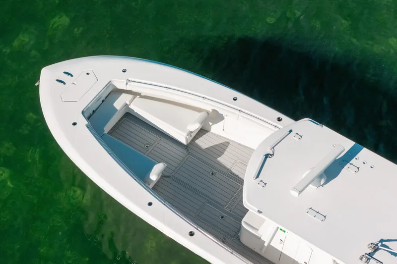  Yacht Photos Pics 2016 Invincible 42 Open Fisherman boat on clear green water, aerial view.