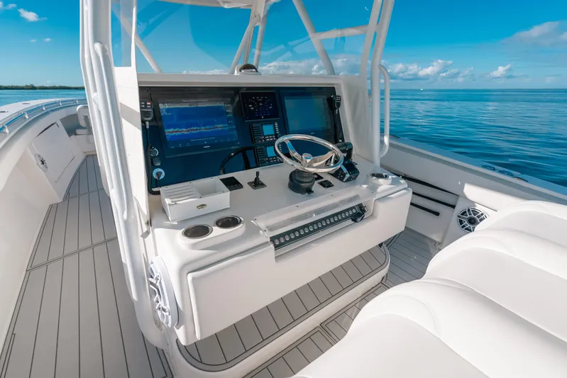  Yacht Photos Pics 2016 Invincible 42 Open Fisherman boat cockpit with modern navigation equipment and ocean view.