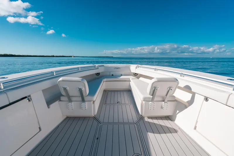  Yacht Photos Pics 2016 Invincible 42 Open Fisherman boat interior with seating, on calm ocean waters.