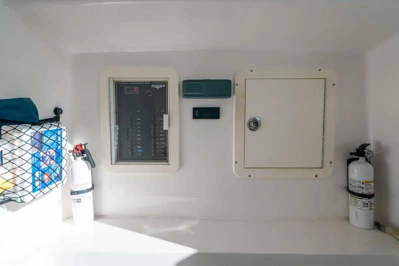  Yacht Photos Pics 2016 Invincible 42 Open Fisherman control panel with fire extinguishers and storage compartment.