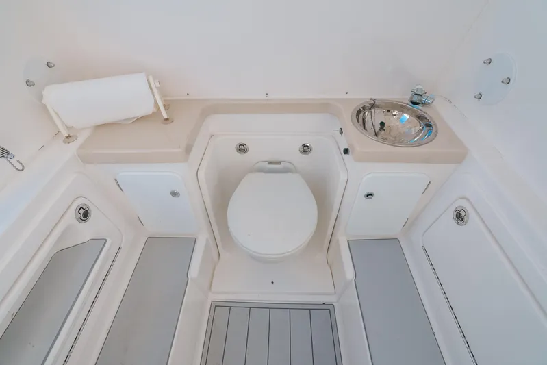  Yacht Photos Pics 2016 Invincible 42 Open Fisherman boat bathroom with toilet and sink.