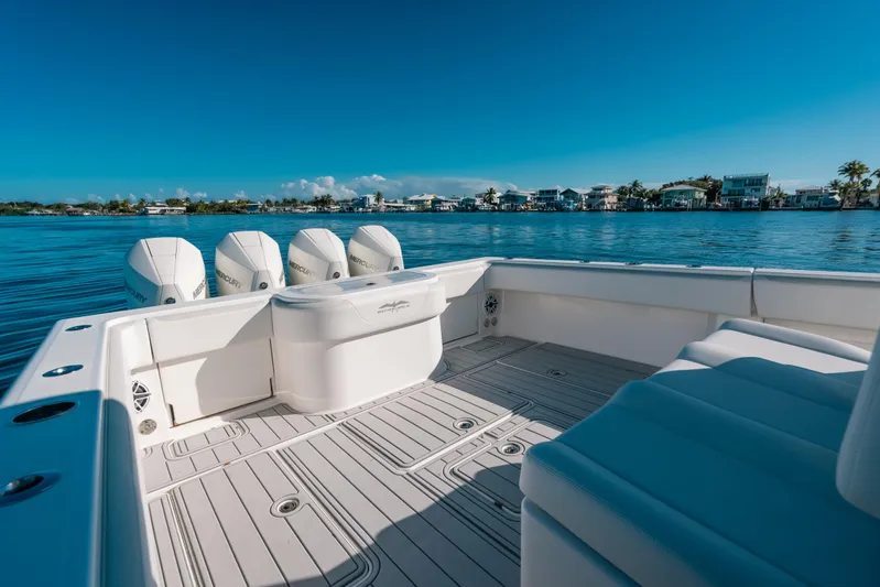  Yacht Photos Pics 2016 Invincible 42 Open Fisherman boat on calm water, featuring multiple outboard engines.