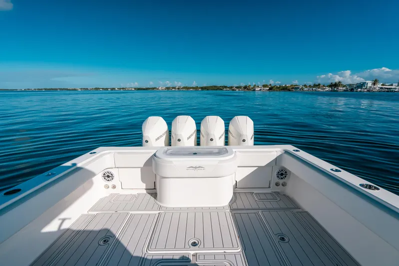  Yacht Photos Pics 2016 Invincible 42 Open Fisherman boat on calm blue waters, featuring multiple outboard engines.
