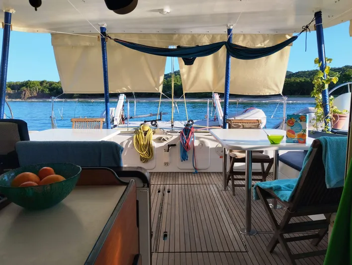  Yacht Photos Pics Lagoon 570 yacht interior with dining area, ocean view, and vibrant decor, 2004 model.