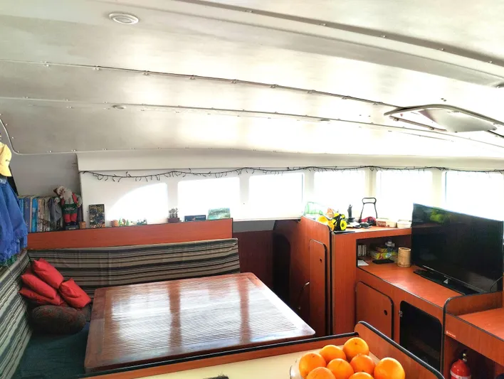  Yacht Photos Pics Interior of 2004 Lagoon 570 yacht with dining area and TV.