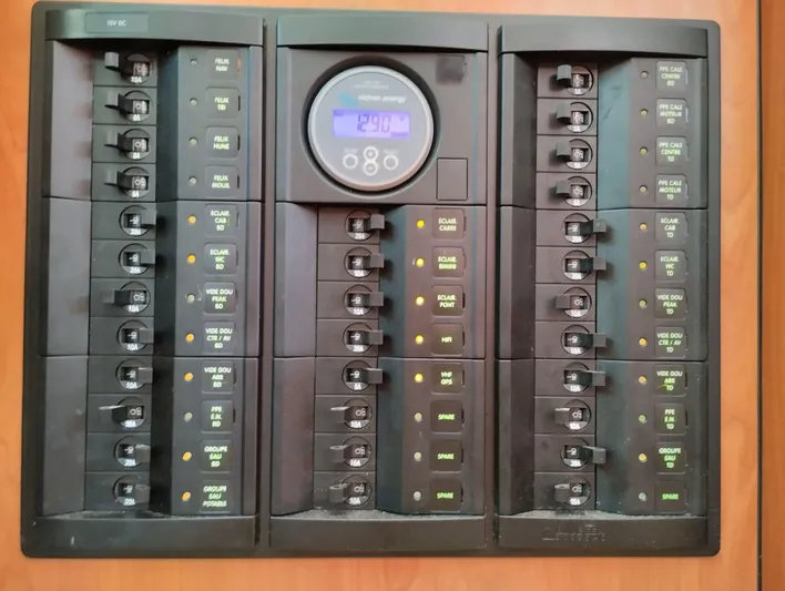  Yacht Photos Pics Electrical panel of a 2004 Lagoon 570 yacht with labeled switches and digital display.