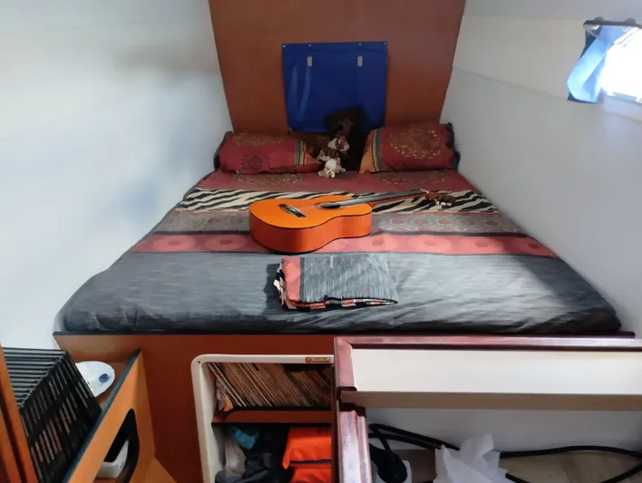  Yacht Photos Pics Cozy cabin bedroom in 2004 Lagoon 570 yacht with guitar on bed.