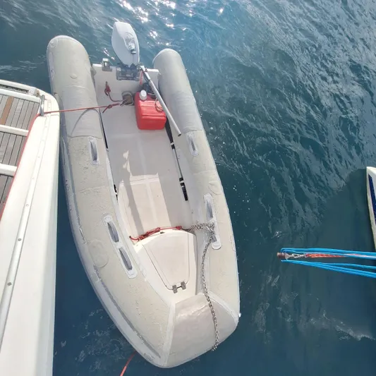  Yacht Photos Pics Inflatable dinghy moored beside a 2004 Lagoon 570 yacht on calm water.