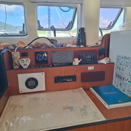  Yacht Photos Pics Navigation station on a 2004 Lagoon 570 catamaran with charts and instruments.