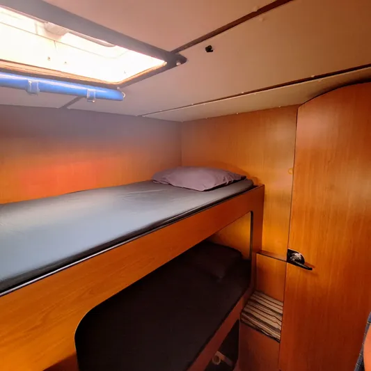  Yacht Photos Pics Interior of 2004 Lagoon 570 yacht cabin with wooden bunk beds.