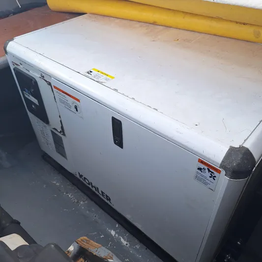  Yacht Photos Pics Kohler generator on 2004 Lagoon 570 yacht, white casing, safety labels visible.