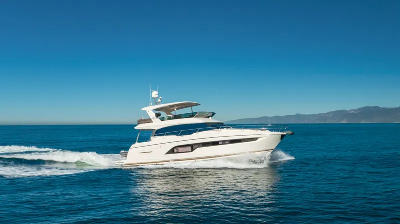 Seaduction Yacht Photos Pics Luxury 2018 Prestige 630 yacht cruising on open sea under clear blue sky.