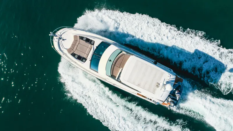 Seaduction Yacht Photos Pics Aerial view of 2018 Prestige 630 yacht cruising on open water.
