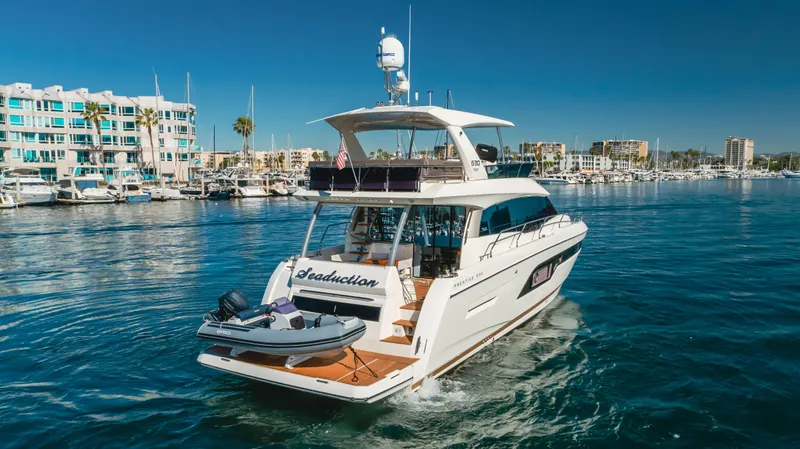 Seaduction Yacht Photos Pics Luxurious 2018 Prestige 630 yacht cruising in a vibrant marina setting.