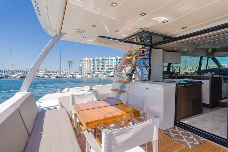 Seaduction Yacht Photos Pics Luxurious 2018 Prestige 630 yacht interior with marina view, featuring elegant seating and dining area.