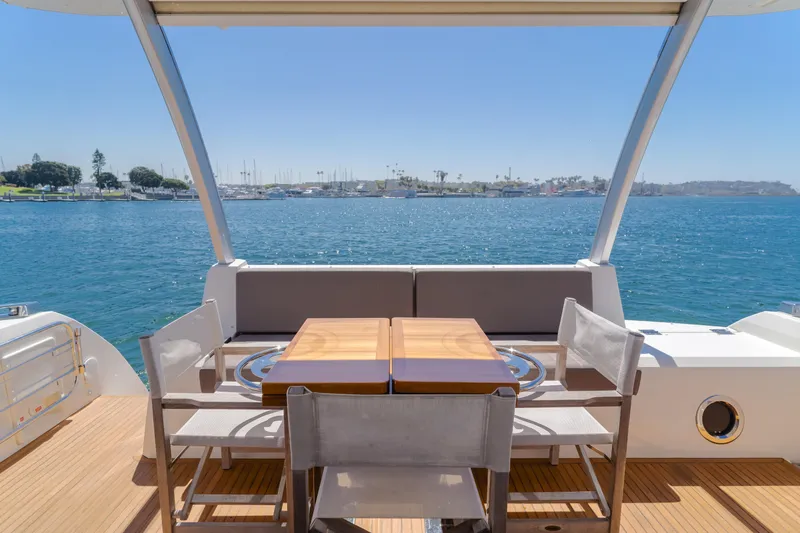 Seaduction Yacht Photos Pics Luxury yacht deck with dining area overlooking the ocean, Prestige 630, 2018 model.