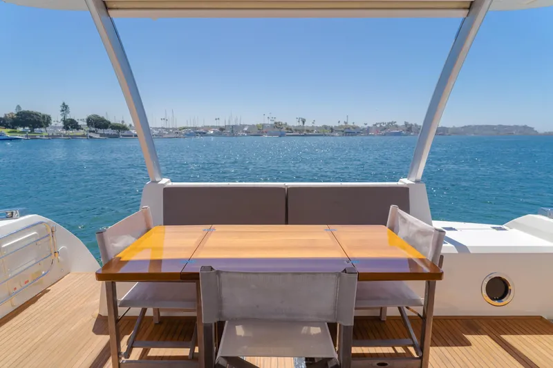 Seaduction Yacht Photos Pics Luxury yacht deck with dining area overlooking serene ocean view, Prestige 630, 2018 model.