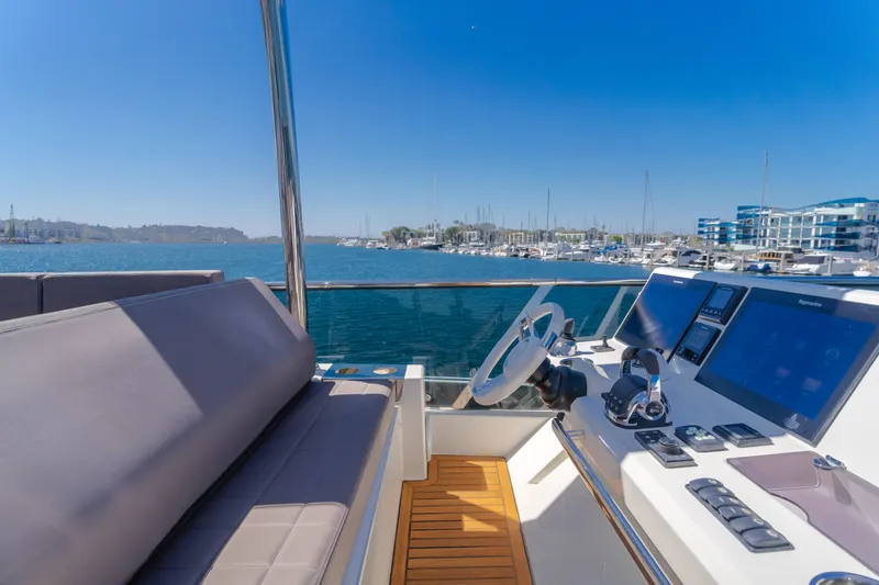 Seaduction Yacht Photos Pics Prestige 630 yacht helm with modern controls, overlooking marina, 2018 model.