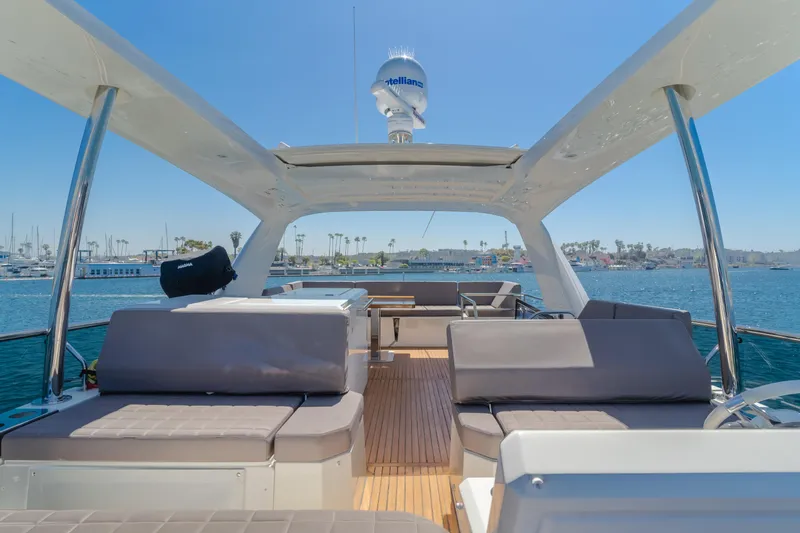 Seaduction Yacht Photos Pics Luxurious 2018 Prestige 630 yacht with spacious deck and seating, docked in a sunny marina.