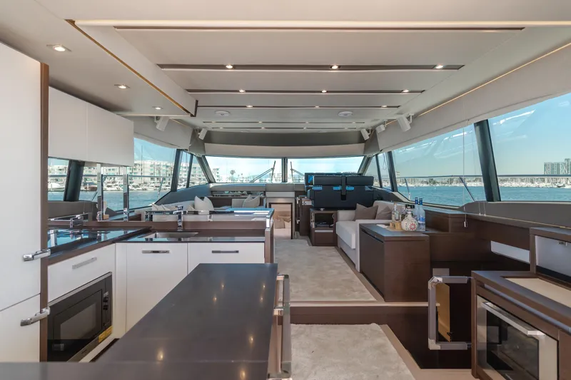 Seaduction Yacht Photos Pics Luxurious interior of 2018 Prestige 630 yacht with modern kitchen and panoramic windows.